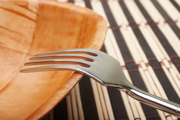 Fork closeup in bowl on placemats — Stock Photo, Image