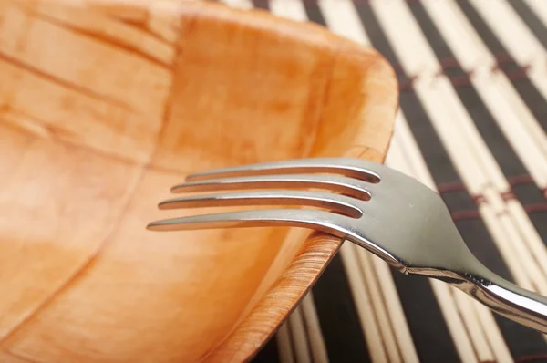 Fork closeup in bowl on placemats — Stock Photo, Image