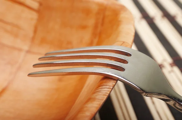 Fork closeup in bowl on placemats — Stock Photo, Image