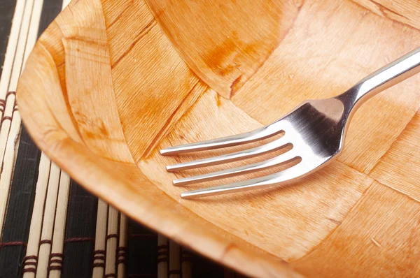 Fork closeup in bowl on placemats — Stock Photo, Image