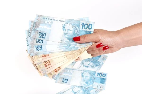 Mano de mujer y dinero brasileño — Foto de Stock