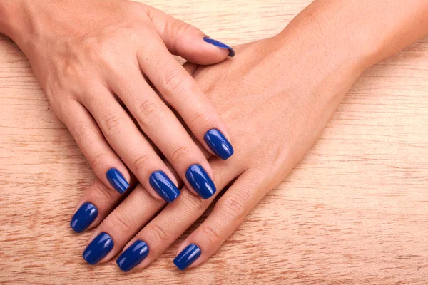 Mains femme avec manucure bleue et vernis à ongles — Photo