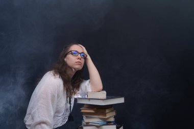 Bayan öğrenci sınavdan önce bir sürü kitaptan kayıyor. Ev eğitimini kabul et.