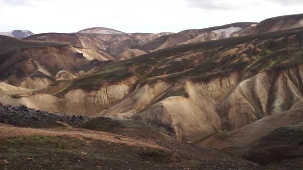 Landmannalaugar Colorful mountains on the Laugavegur hiking trail. Iceland. The combination of layers of multi-colored rocks, minerals, grass and moss — Stock Video