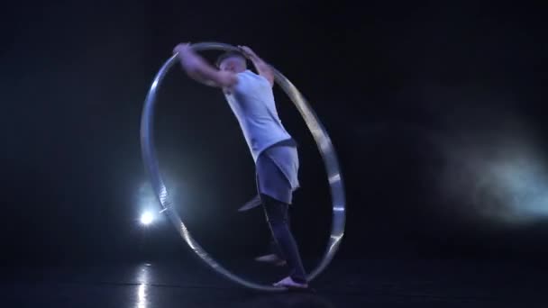 Muscular athlete doing tricks on a Cyr wheel in slow motion. Concept of control and concentration — Stock Video