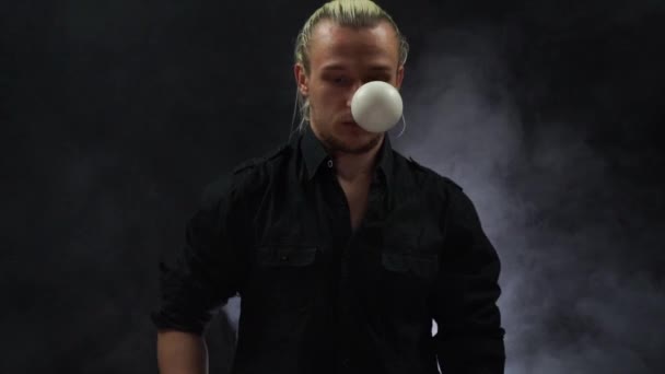 Muž v černém žongluje s bílými koulemi. Koncentrace, kontrola a schopnost. — Stock video