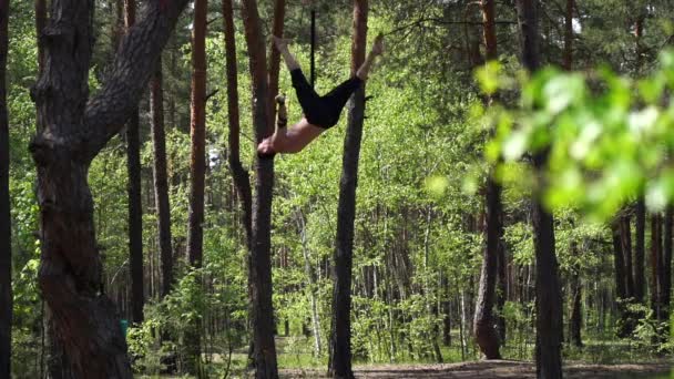 Artysta cyrkowy uprawia sporty w zielonym parku z paskami powietrznymi slow motion — Wideo stockowe