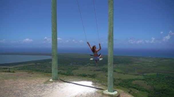 Jeune femme sur la corde balançoire avec fond de mer et ciel, vue de la montagne Redonda. Concept de vacances et de voyage — Video