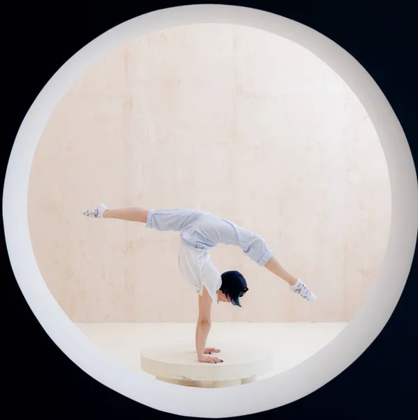 Flexibel tjej gör stretching och handställ i studio. Begreppet individualitet, kreativitet och självförtroende — Stockfoto
