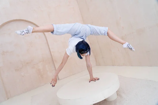 Flexibele meisje praktijk stretching en handstand thuis. concept van gezonde levensstijl en yoga — Stockfoto
