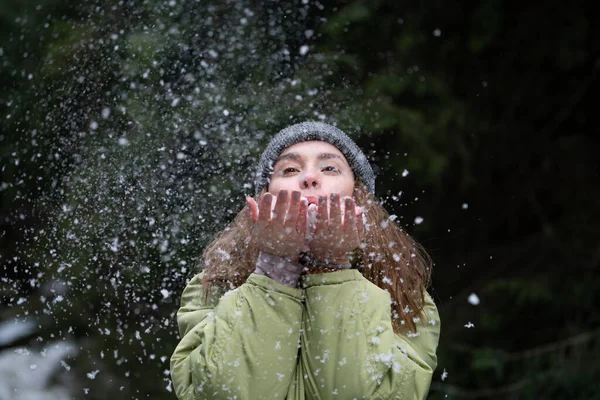 Woman Blowing Snow Outdoor on Winter background. Happiness and joy concept — Stock Photo, Image