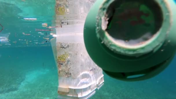 Máscaras protetoras e lixo plástico flutuando sob a água. Poluição do ambiente e conceito de questão ecológica — Vídeo de Stock