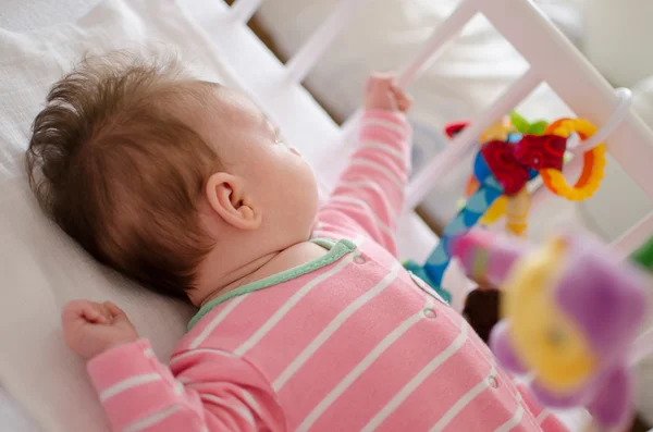 Baby in a cot Royalty Free Stock Photos