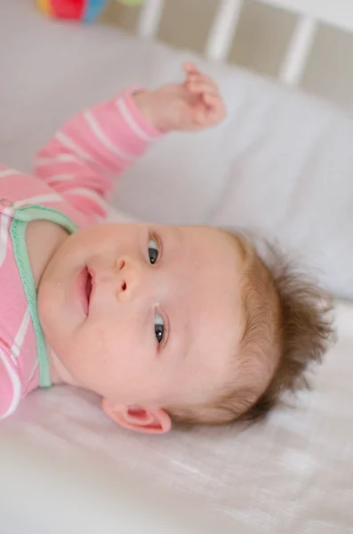 Baby in a cot — Stock Photo, Image