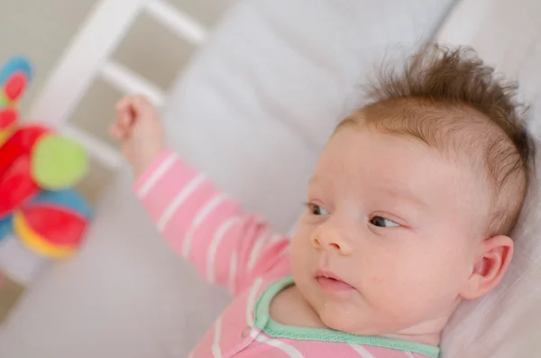 Baby in a cot — Stock Photo, Image