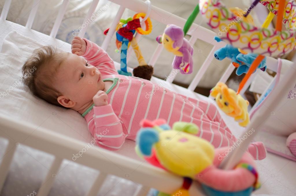 Baby in a cot — Stock Photo © Dessie_bg 100561164