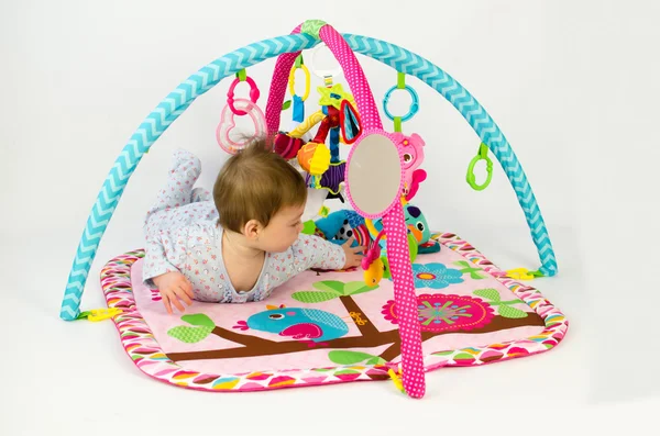 Baby girl playing in an activity gym — Stock Photo, Image