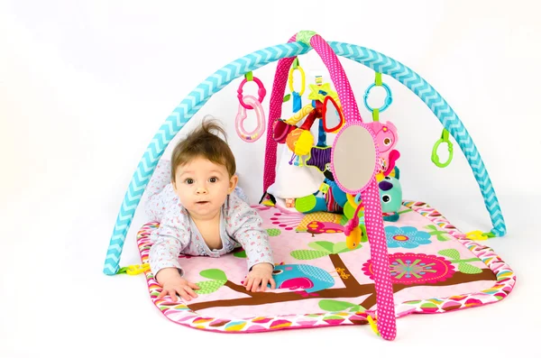 Baby girl playing in an activity gym — Stock Photo, Image