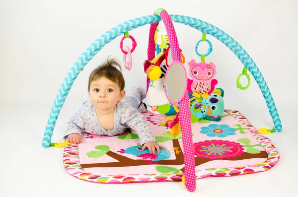 stock image baby girl playing in an activity gym