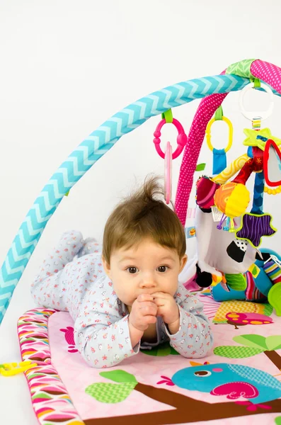 Baby girl palying in an activity gym — Stock Photo, Image