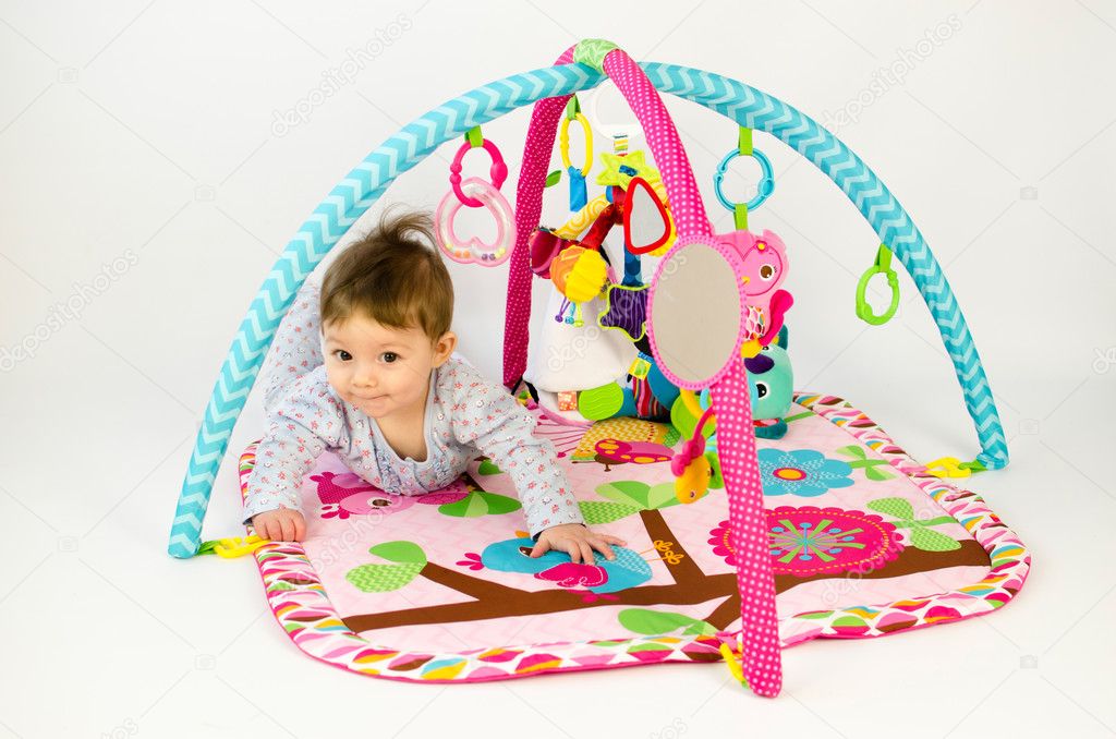 baby girl palying in an activity gym