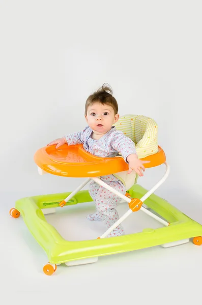 Baby girl in a walker — Stock Photo, Image