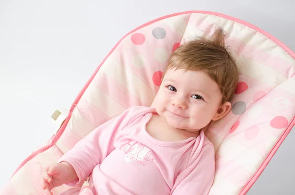 Baby girl on a bouncer — Stock Photo, Image