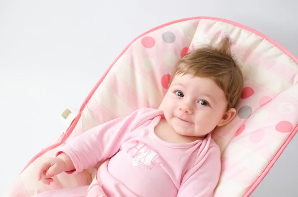 Baby girl on a bouncer — Stock Photo, Image