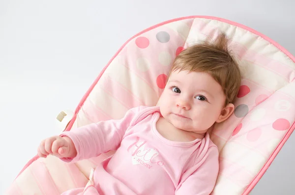 Baby girl on a bouncer — Stock Photo, Image