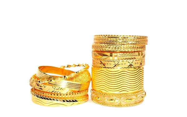 Gold bracelets on white — Stock Photo, Image