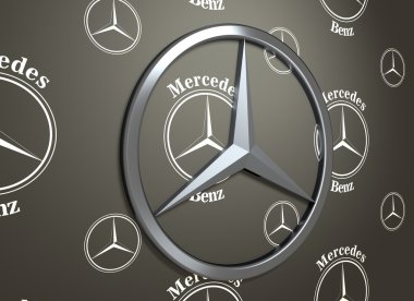 Koyu gri arka plan üzerinde Mercedes Benz amblemi.
