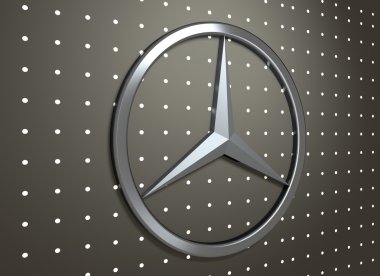 Koyu gri arka plan üzerinde Mercedes Benz amblemi.