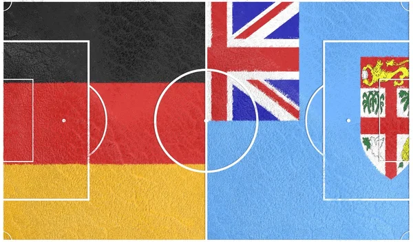 Tyskland mot Fiji. Fotbollsplan texturerat av flaggor — Stockfoto