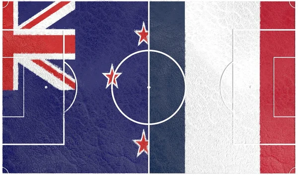 Frankrike mot nya Zeeland. Fotbollsplan texturerat av flaggor — Stockfoto