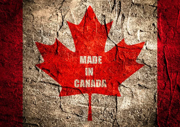 Kanada bayrağı akçaağaç yaprağı grunge zemin üzerinde — Stok fotoğraf