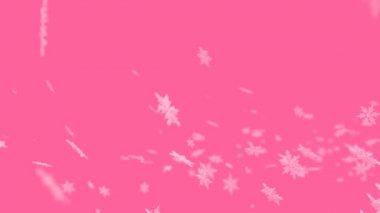 Pembe zemin üzerinde uçan bulanık kar taneleri