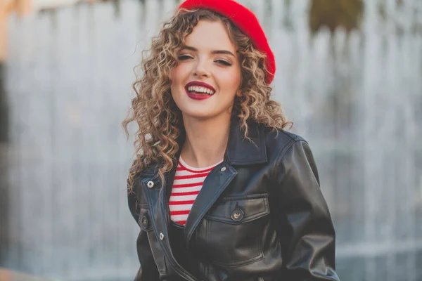 Happy smiling woman in french style clothes outdoor portrait