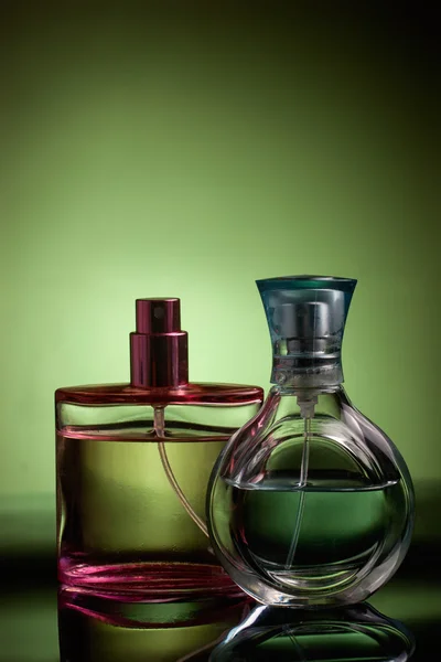 Parfumflesjes geïsoleerd op groen — Stockfoto