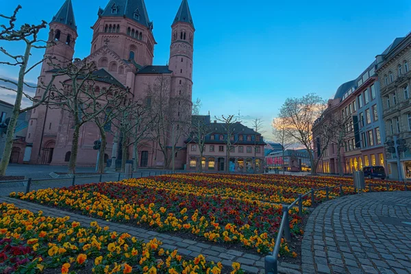 Medieval european church with flowerbed outside — Stock Photo, Image