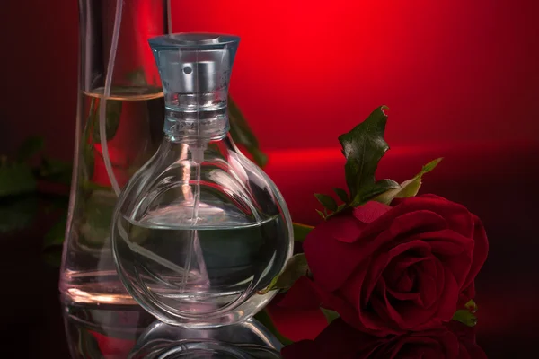Perfume bottles with rose — Stock Photo, Image
