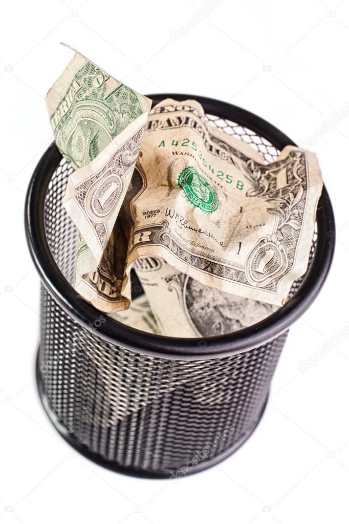 Dollars in a trash bin