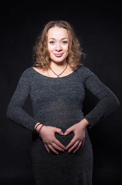 Photographing a pregnant woman in a studio in different positions — Stock Photo, Image