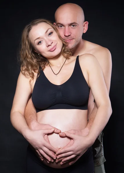 Photography pregnant woman with her husband hugging her from behind — Stock Photo, Image