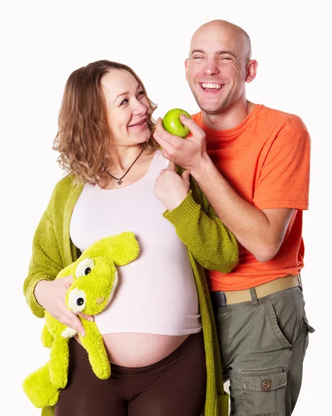 The pregnant woman with her husband with green apple — Stock Photo, Image