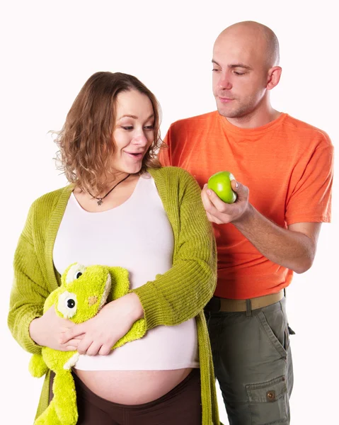 The pregnant woman with her husband with green apple — Stock Photo, Image