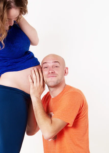 The husband overhears in the belly of his wife — Stock Photo, Image