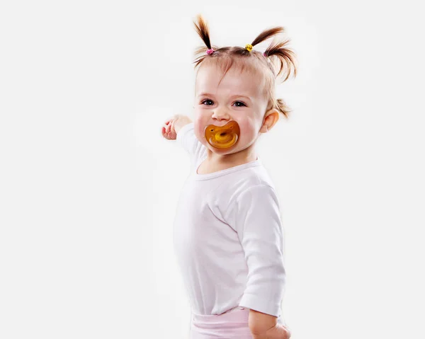 The baby girl with a pacifier in gouache soiled hands and shirt isolated — Stock Photo, Image
