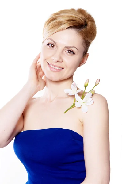 The blonde woman with long hair holding a flower orchid isolated — Stock Photo, Image