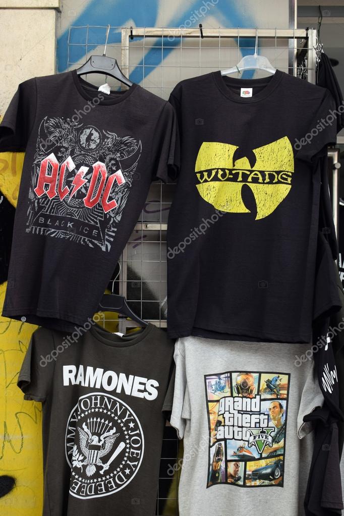 ATHENS, GREECE - AUGUST 4, 2016: Rock and hip hop music t-shirts for sale printed with band logos by The Ramones, AC/DC, Wu-Tang Clan and video game Grand Theft Auto.