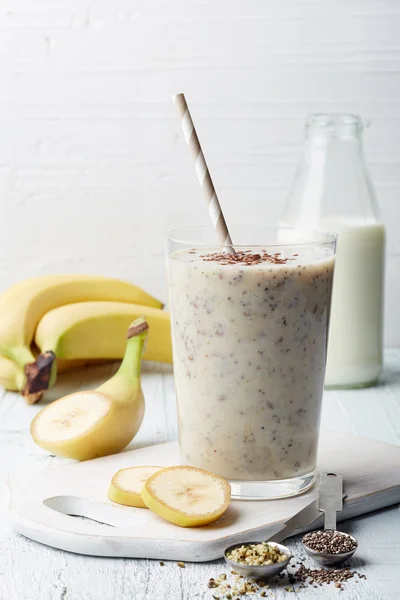 Glass of healthy banana and seeds smoothie — Stock Photo, Image